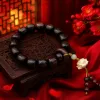 A dark brown wooden lotus-carved bracelet with small beaded tassels Specification image